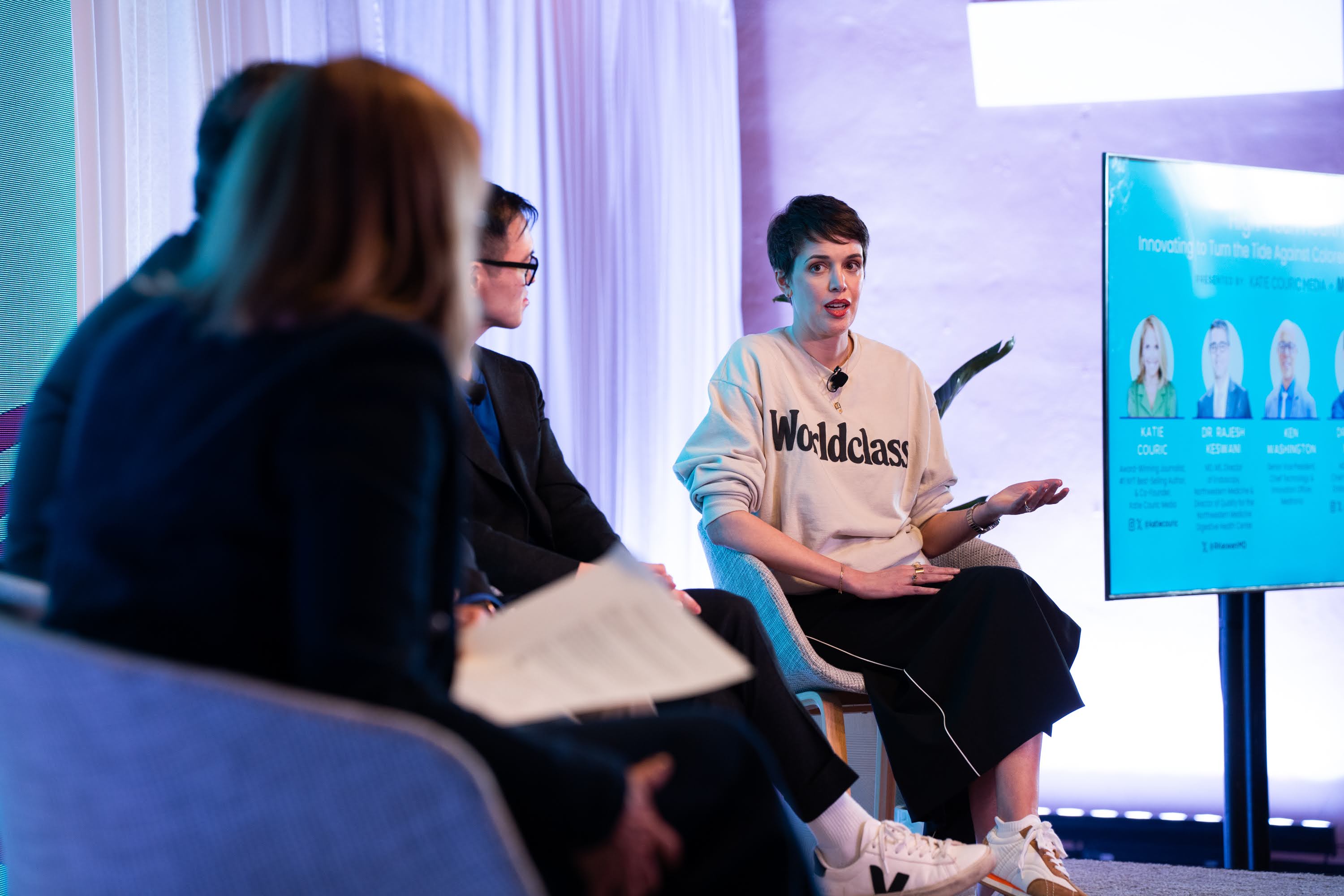 Brooks Bell speaking at SHE Media in a Worldclass sweatshirt